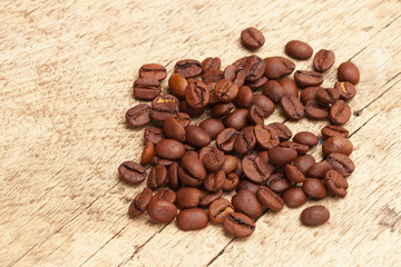 Coffee beans over old wooden table