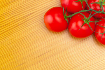 Bunch of red tomatoes on wooden table - view from top