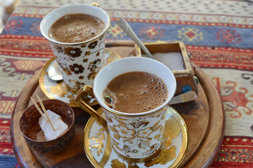 Two cups of Turkish coffee on a Persian rug