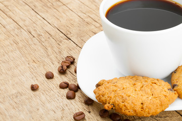 Cup of black coffee on old wooden table