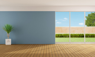 Empty living room with blue wall and large windows 