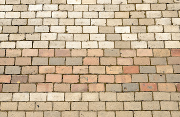 Pavement bricks of beige and pinkish colors as background.