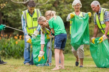 Happy family collecting rubbish 