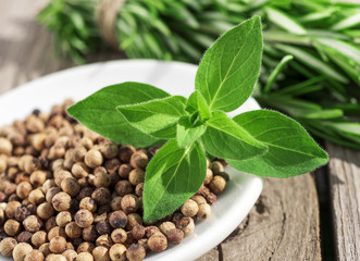 oregano leaves and peppercorns