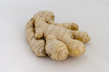 Fresh ginger root sliced on white background.