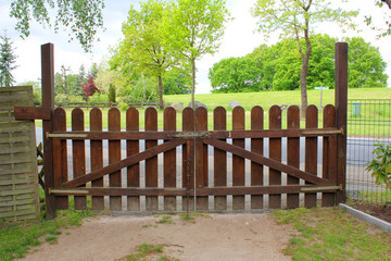 The closed brown wooden gate