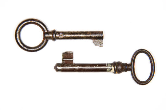 Two old keys to the safe on a white background