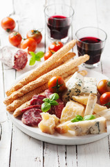 Concept of italian antipasto with cheese and sausage