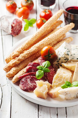 Concept of italian antipasto with cheese and sausage
