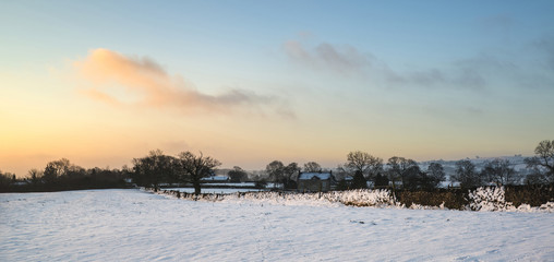 Beautiful snow covered sunrise Winter rural landscape