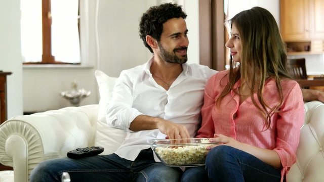 Couple watching tv in their apartment