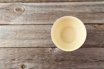 Fototapeta na wymiar Empty bowl on grey wooden background