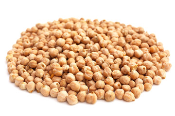 Plate with raw chickpeas on white background