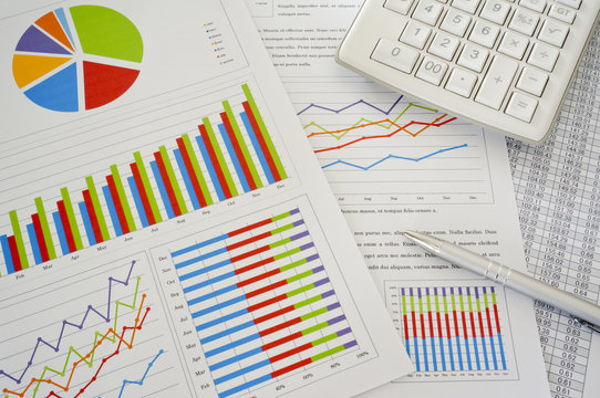 Colorful Charts And Spreadsheet With Calculator And Pen