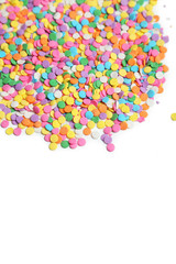 Colorful sprinkles on white background