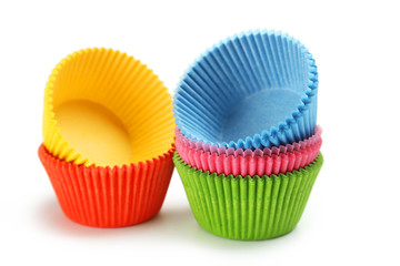Empty colorful cupcake cases isolated on white