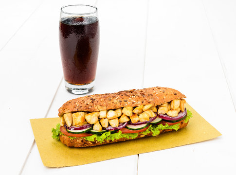 Hot sandwich with chicken, vegetables and drink