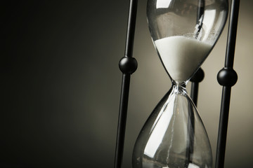Black hourglass on black background