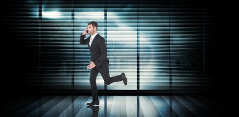 Fototapeta na wymiar Composite image of businessman running on the phone 
