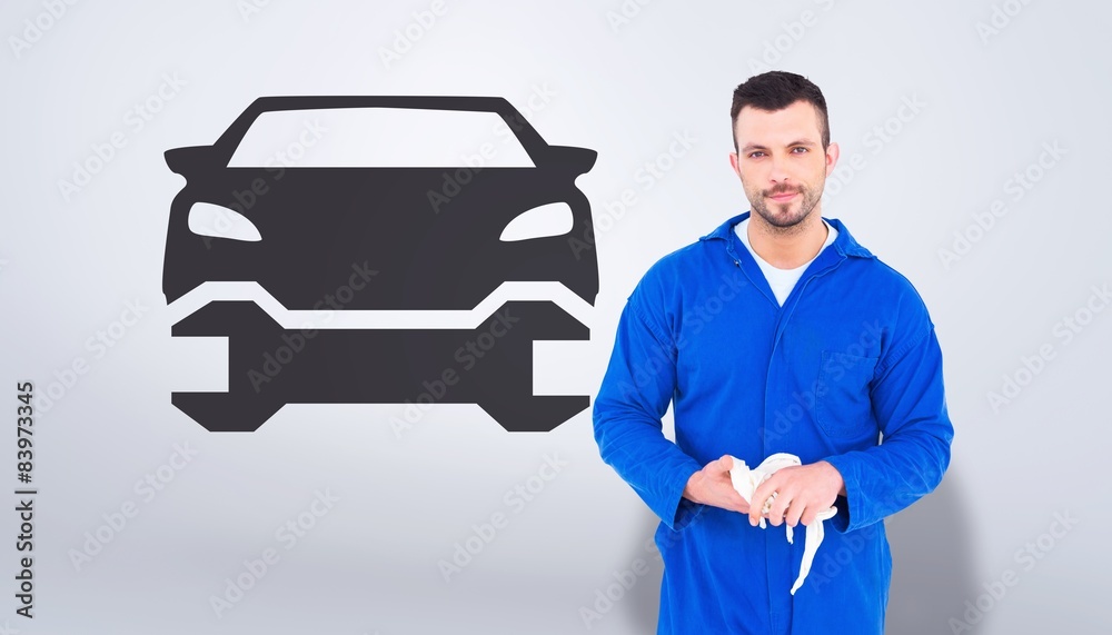 Aufkleber composite image of mechanic wiping hands with cloth