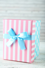 Beautiful gift box on white wooden background