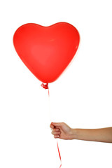 Obraz na płótnie Canvas Hand holding a red heart balloon isolated on white