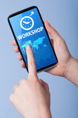 Man presses a touch screen smart phone with the symbol of  an  w