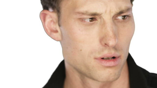 Man looks up with a sad face into the camera on a white background