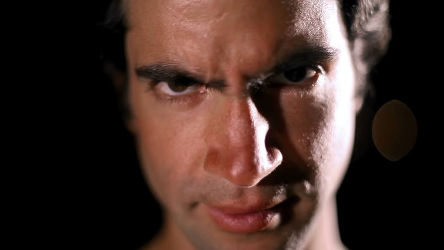 A good looking man gives the camera a serious look