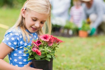 Young girl sitting with flower pot 