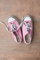 Close up of pink sneakers worn by a teenager 