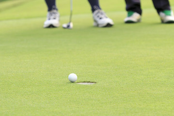 Golf ball on the edge of hole