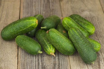 Fresh cucumbers on the aged wooden table.