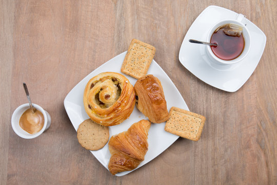 Coffee and tea at morning breakfast with sweets pastries and cakes top view