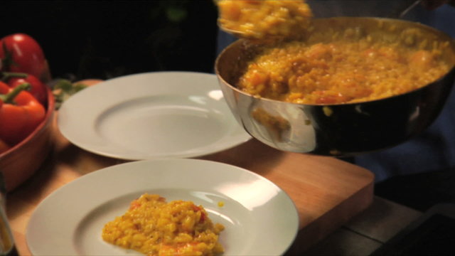 Rice in a pan being served on two plates 