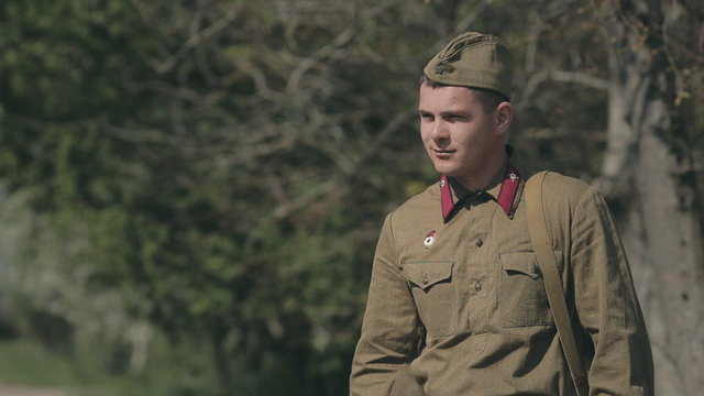Two amicable soldier meet, shaking hands with each other and go