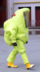 man with yellow protective suit against biological risk