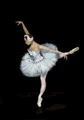 Fototapeta na wymiar Ballerina dancing on a black background