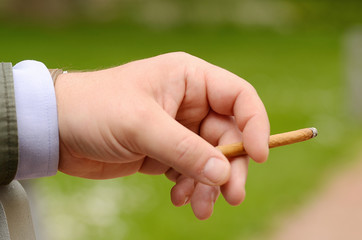 Male hand holding a cigarette