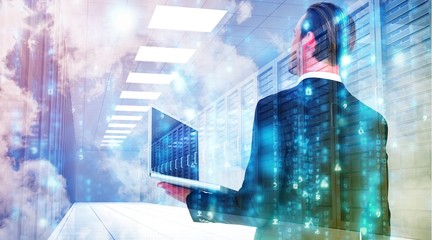 Composite image of businessman looking up holding laptop