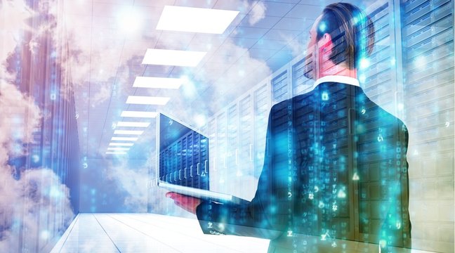 Composite image of businessman looking up holding laptop