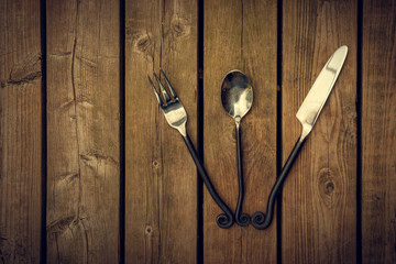 Vintage Cutlery - Fork, Spoon and Knife Fanned on Wood Backgroun