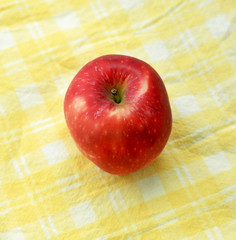 Red apple on a tablecloth
