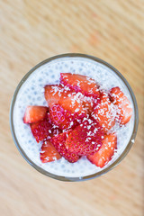 Coconut Milk Chia Seeds Pudding with Strawberries and Dried Coconut