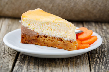 Sweet slice of carrot cake on white plate.