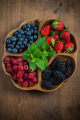 Farm fresh summer berries in wooden tray