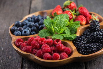 Farm fresh summer berries in wooden tray