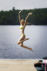 Fototapeta na wymiar girl jumping into a lake
