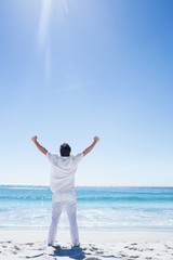 Man stretching his arms in front of the sea