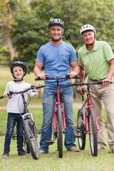 Happy multi generation family on their bike at the park 